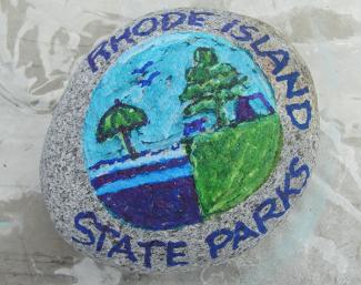 A stone painted with the RI State Parks logo