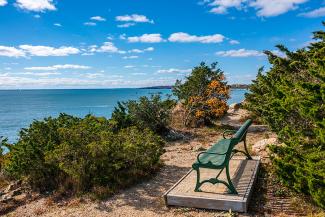 A green bench overlooks Narragansett Bay