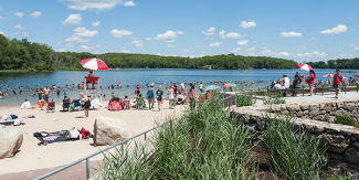 A busy beach day at the swimming area at Lincoln Woods State Park 